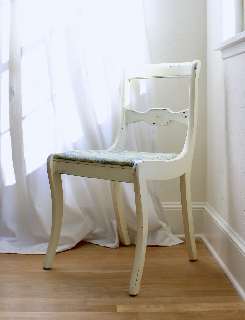 white chair with blue and green fabric seat