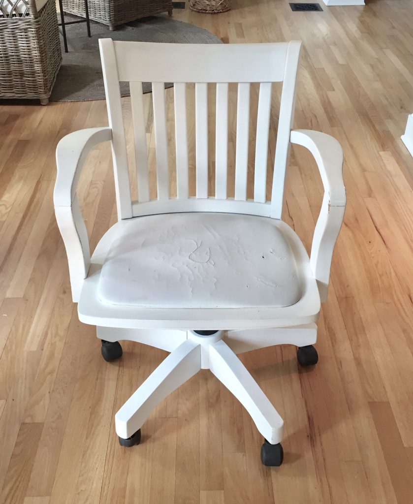 Old white chair with torn fabric on seat