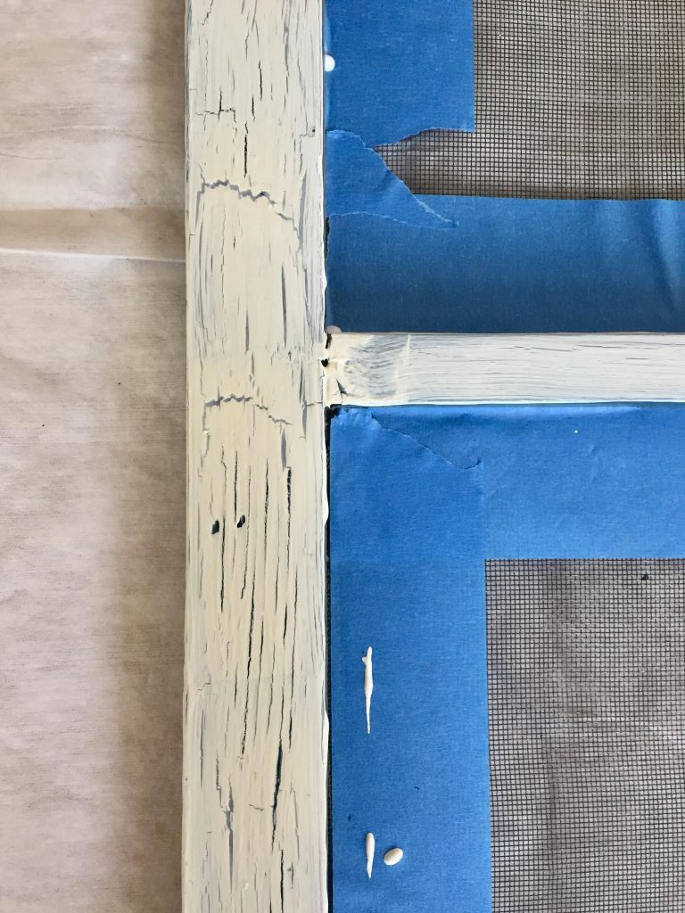 Original blue paint shows through the cracks