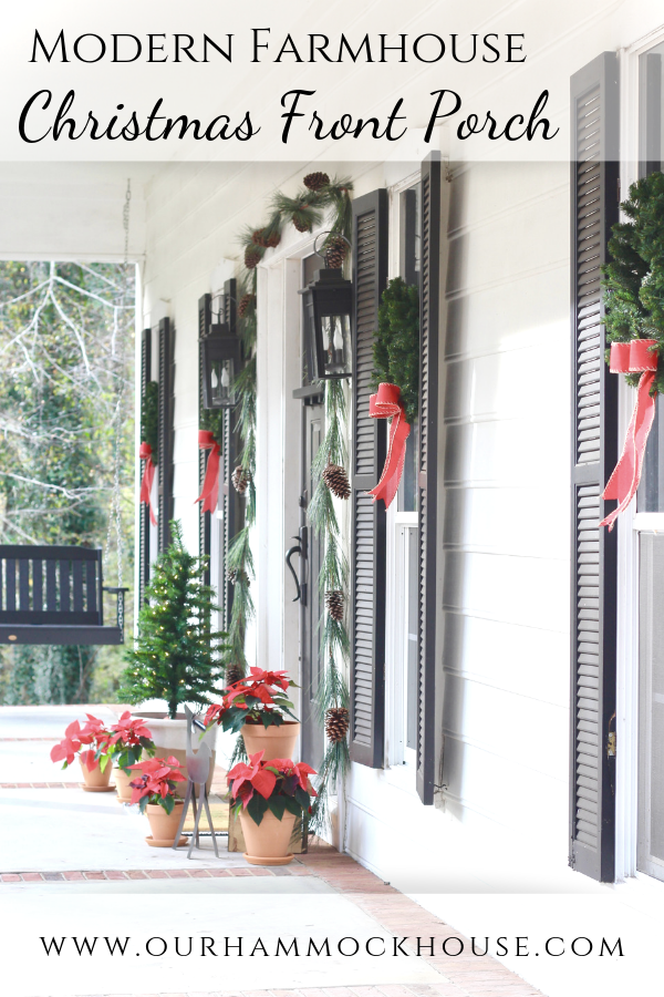 White modern farmhouse with black shutters and wreaths with red bows on the windows | #modernfarmhouse #frontporch #Christmasdecor #wreath #porchswing 