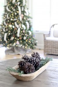 Neutral Christmas Decor - centerpiece made of pine tree trimmings clippings greenery and pine cones in wooden dough bowl | www.ourhammockhouse.com