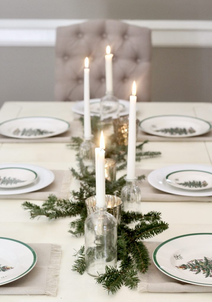 Christmas tablescape table setting with white candles, greenery, and mercury glass candleholders | #Christmasdecor #tablescape #mercuryglass 