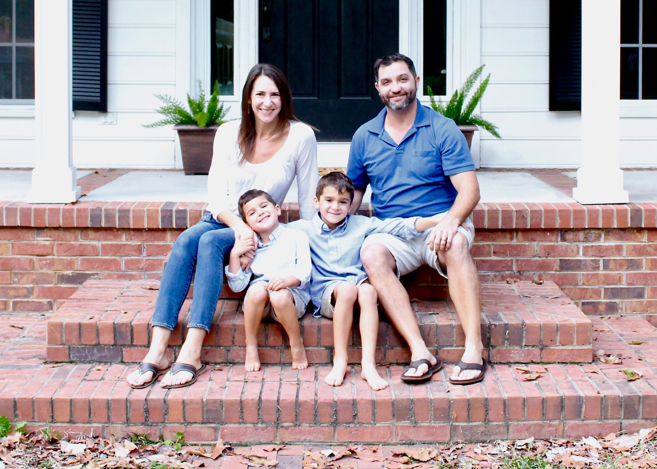 Family on front porch of house