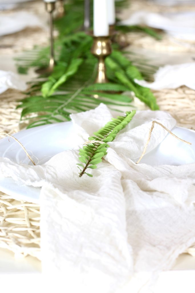 DIY gauze napkins using cheesecloth - tie with twine and tuck in some greenery to create a natural, organic table setting | #DIYnapkins #gauzenapkins #cheeseclothnapkins #springtable #springdecor 