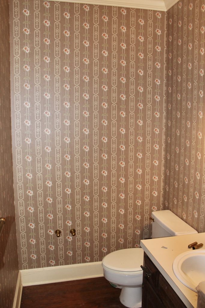 Dated 80s powder room with mauve floral wallpaper