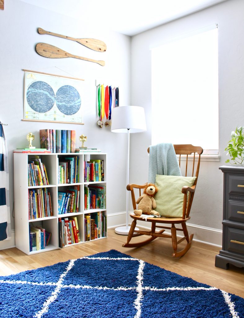 Boys adventure theme bedroom with rocking chair and books | www.ourhammockhouse.com | #boysbedroom #kidsroom #graydresser