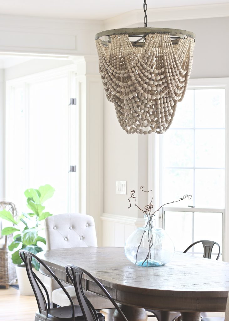 Tips for finding your personal design style | Wood beaded chandelier in breakfast nook with linen end chairs | www.ourhammockhouse.com | #woodbeadchandelier #breakfastnook #cottagestyle 