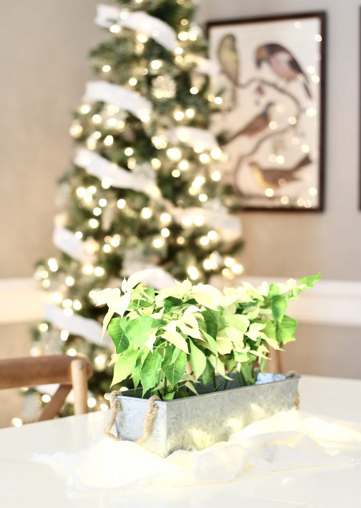 Christmas Home Tour 2019 | Dining room with white poinsettia centerpiece and fairy lights | www.ourhammockhouse.com | #christmastablescape