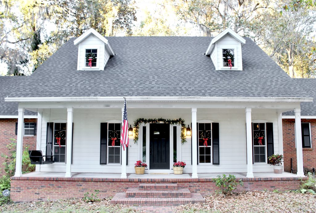 Christmas Home Tour 2019 | Modern Farmhouse Christmas Front Porch with black front door, lit garland, red poinsettias, and window wreaths | www.ourhammockhouse.com | #christmasfrontporch 