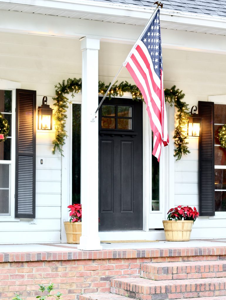 Christmas Home Tour 2019 | Modern Farmhouse Christmas Front Porch with black front door, lit garland, red poinsettias, and window wreaths | www.ourhammockhouse.com | #christmasfrontporch 